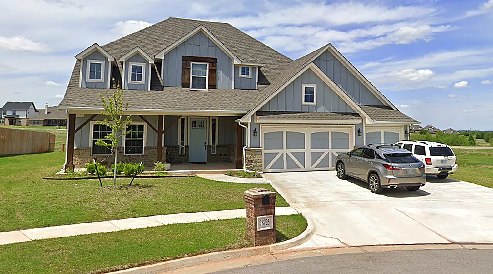 After: finished two-story home with stone accents and a two-car garage